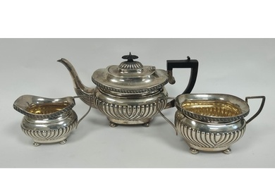 Silver three piece tea set of fluted boat shape by Sheffield...