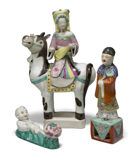 Three Chinese export porcelain famille rose figure groups, Republic period, comprising a lady on a donkey, 28cm high, an attendant, 20cm high, and a boy with a lotus flower, 13cm long (3)