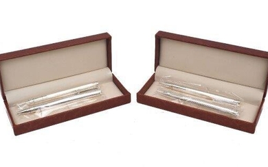 Two cased pairs of silver ballpoint pens, one pair London, 2014, with engine turned pattern to barrels, the other pair of striated design, London 2014 and 2015, 13.5cm long (4)