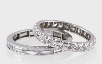 Two diamond and platinum eternity band rings