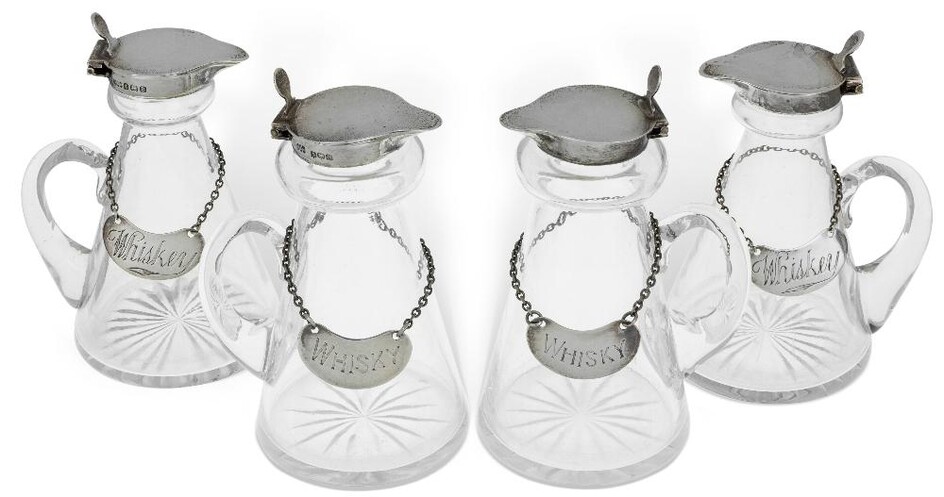 Two pairs of silver mounted whisky noggins by Hukin & Heath, the first pair Birmingham, 1926, with silver decanter labels engraved 'whiskey', (same date and maker), the second pair Birmingham, 1937, with silver decanter labels engraved 'whisky'...
