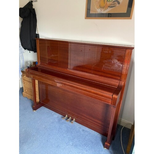 Welmar (c1998) An upright piano in a bright mahogany traditi...