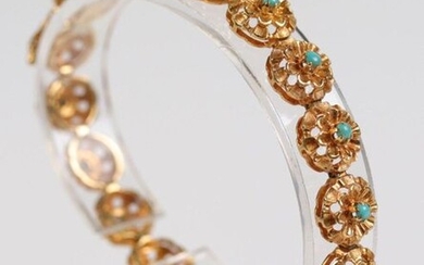Yellow gold bracelet (750) decorated with 18 flowers each centered...