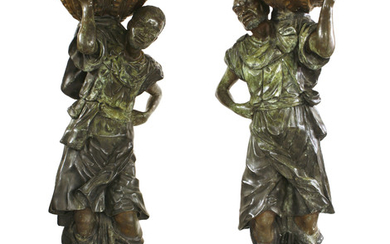 A pair of life-sized green patinated bronze blackamoors