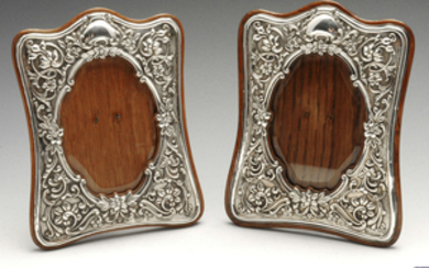 A matched pair of late Victorian and later silver mounted photograph frames.