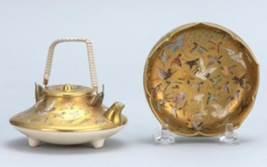 TWO PIECES OF SATSUMA POTTERY A wine pot and a small bowl with pinched rim. Both pieces with bird decoration on a gold ground. Match...