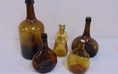5 early glass bottles, amber colored, includes figural