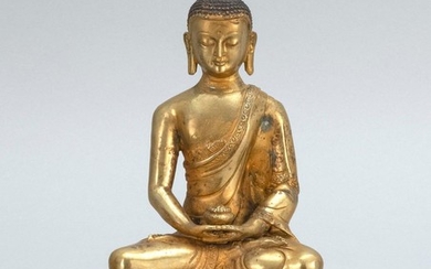 SINO-TIBETAN GILT-BRONZE FIGURE OF BUDDHA Seated in lotus posture on a two-tier lotus base and holding a censer. Height 7.8".