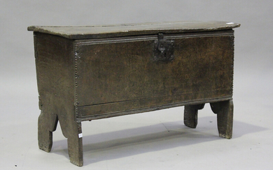 A 17th century oak six-plank coffer, the hinged lid revealing a candlebox, on shaped supports, heigh