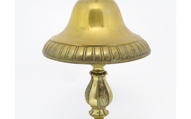 A 20thC brass table lamp with foliate detail and brass domed...