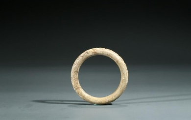 A CALCIFIED JADE 'CHILONG AND INSCRIPTION' BANGLE