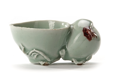 A CHINESE CELADON WATER DROPPER IN THE SHAPE OF A PEACH, 18TH CENTURY
