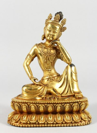 A CHINESE GILT BRONZE FIGURE OF A SEATED DEITY. 8ins