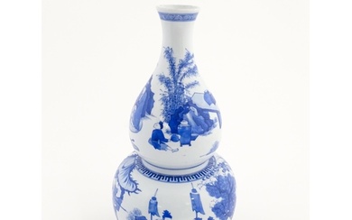 A Chinese blue and white double gourd vase decorated with fi...