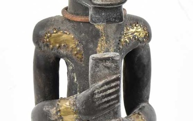 A Fang reliquary figure, Gabon, applied with brass detail and...