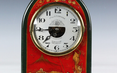 A French red chinoiserie cased electric mantel timepiece, the circular silvered dial with Arabic hou