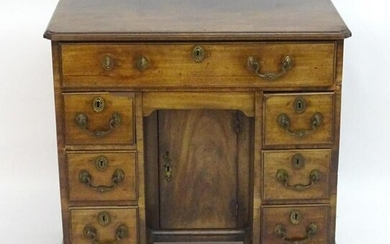 A George III mahogany secretaire kneehole desk with