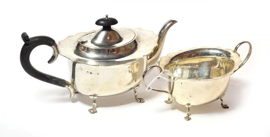 A George V silver teapot and sugar-bowl, maker's mark probably...