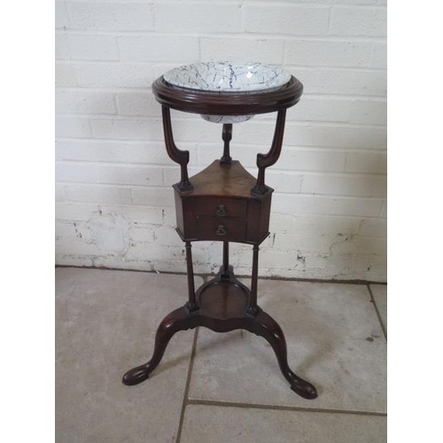A Georgian mahogany wash/wig stand with two small drawers an...