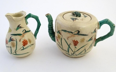 A Japanese teapot and milk jug with hand painted