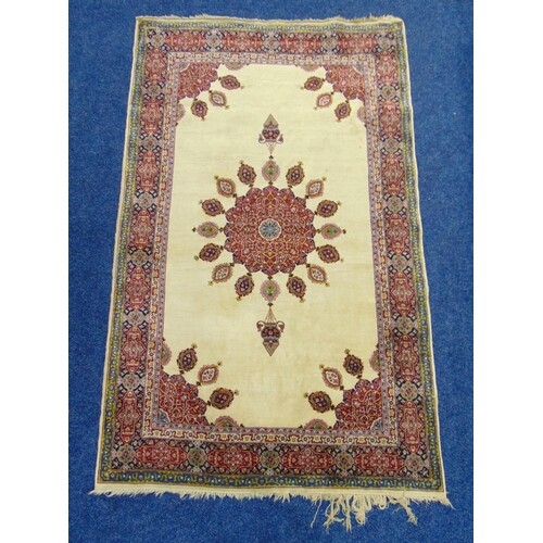 A Middle Eastern wool carpet cream ground with red and blue ...