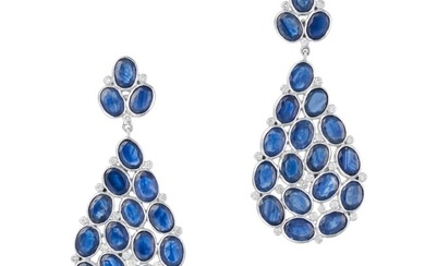 A PAIR OF SAPPHIRE AND DIAMOND DROP EARRINGS each set with a cluster of oval cut sapphires and round