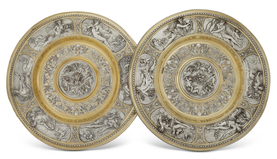 A PAIR OF VICTORIAN PARCEL-GILT ELECTROTYPE CHARGERS MARK OF ELKINGTON & CO., BIRMINGHAM, CIRCA 1875, DESIGNED BY LEONARD MOREL-LADEUIL