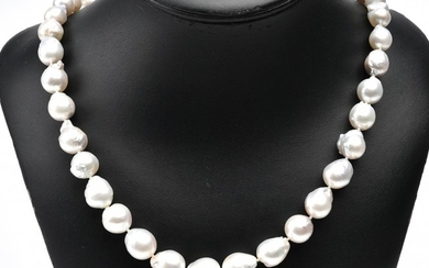 A STRAND OF THIRTY NINE BAROQUE SOUTH SEA PEARLS TO A STERLING SILVER CLASP