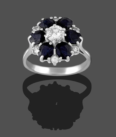 A Sapphire and Diamond Cluster Ring, the round brilliant cut...