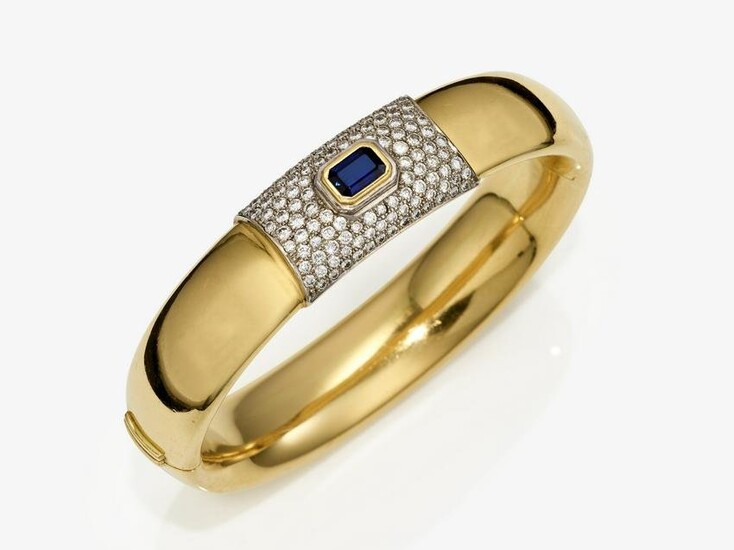 A bangle with a sapphire and brilliant cut diamonds
