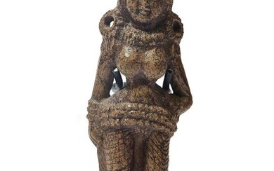 A carved bone figure of a Yakshi, Chandraketugarh style, Sunga, North India, 1st century BC - 1st century AD, the voluptuous figure carved in the round and shows standing on an oval plinth, with elaborate hair style and large hoop earrings, on...