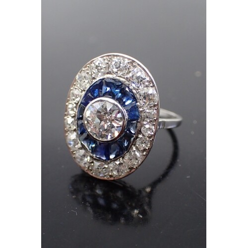A diamond and sapphire cluster ring, estimated weight of cen...