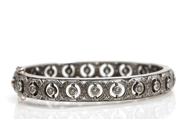 A diamond bangle set with numerous brilliant-cut diamonds, mounted in sterling silver....