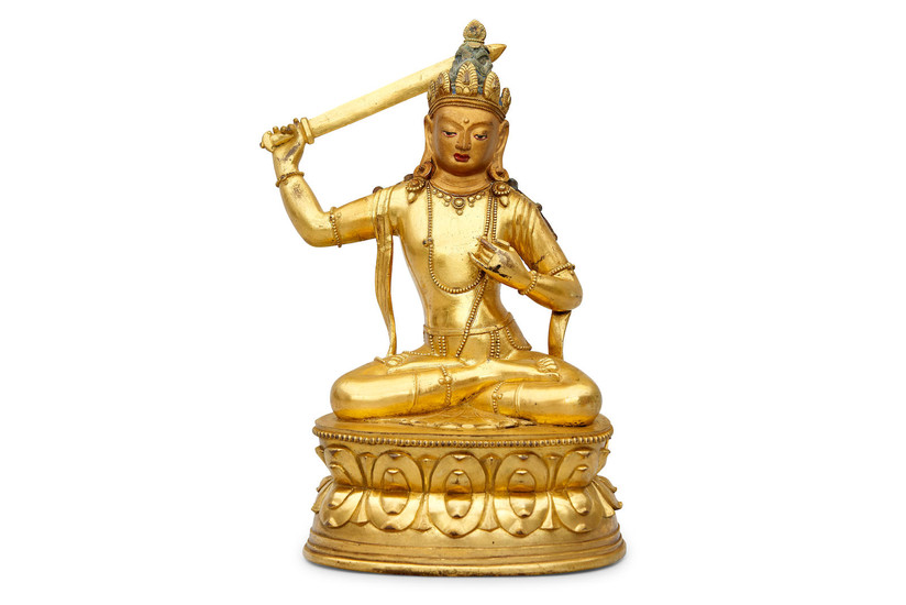 A gilt copper alloy figure of a seated Manjushri