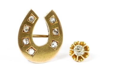 A gold diamond horseshoe brooch