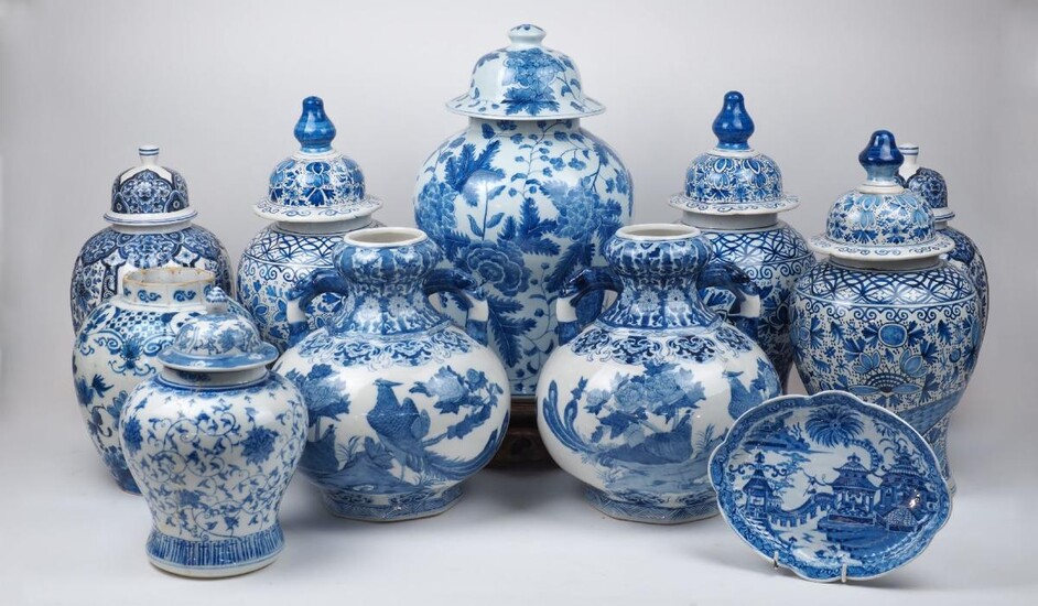 A group of blue and white ceramics, 20th century, comprising: a pair of Delft vases and covers, 43cm high; a similar Delft vase, 41cm high; a pair of Chinese twin handled vases, the bodies decorated with birds and flowers, 31cm high; a large...