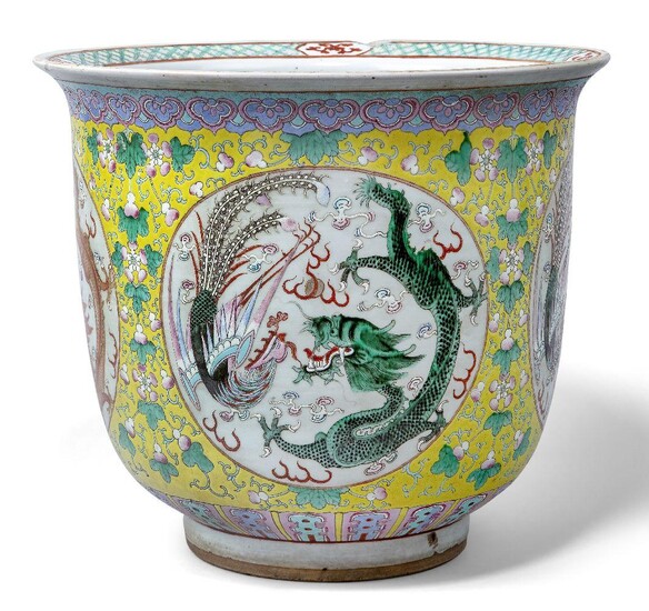 A large Chinese porcelain famille rose 'dragon and phoenix' jardinière, late 19th century, painted with panels enclosing dragons and phoenixes amidst swirling clouds and flaming pearls, with scrolling leafy vines issuing fruit on a yellow ground...