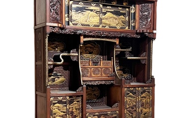 A late 19th Century Japanese Meiji period black lacquer chinoiserie & inlaid display cabinet. The cabinet with carved fret pierced panel top with gilt decoration and gilding throughout. Various shelves and cupboard doors with the base being carved...
