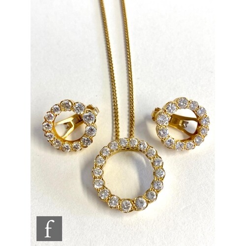 A matching 18ct diamond pendant and earrings, the open circu...