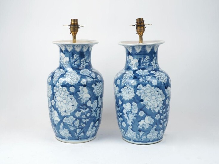 A pair of Chinese porcelain vases, 20th century, of blue and white colourway depicting chrysanthemums and other flora (2) It is the buyer's responsibility to ensure that electrical items are professionally rewired for use.