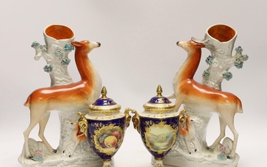 A pair of Coalport vases and covers and a pair of Staffordsh...