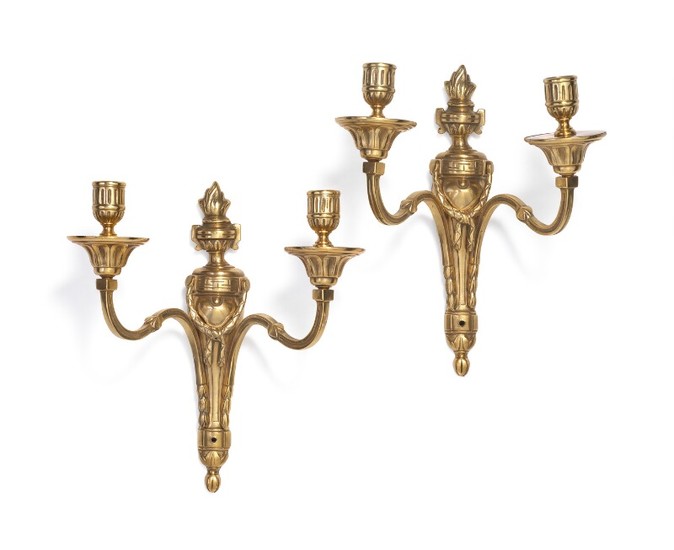 A pair of French Louis XVI gilt bronze wall lights each adorned with urn and festoons. Late 18th century. H. 29 cm. (2)