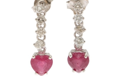 A pair of ear pendants each set with a ruby, totalling app. 1.75 ct. flanked by four diamonds, totalling app. 0.40 ct., mounted in 14k white gold. L. 20 mm. (2)