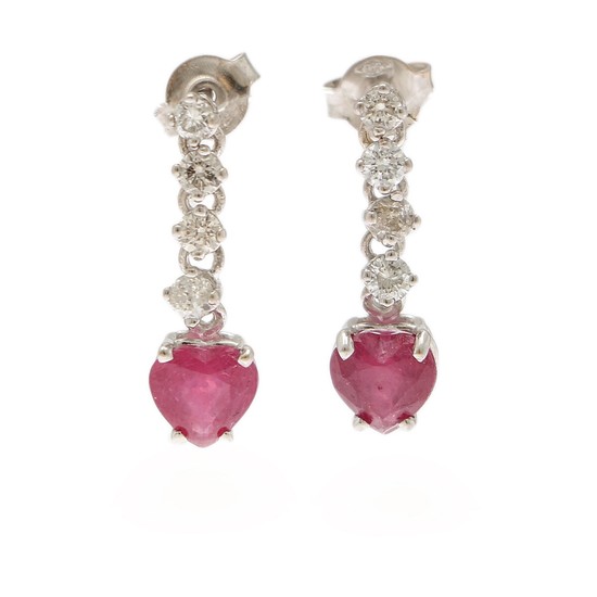 A pair of ear pendants each set with a ruby, totalling app. 1.75 ct. flanked by four diamonds, totalling app. 0.40 ct., mounted in 14k white gold. L. 20 mm. (2)