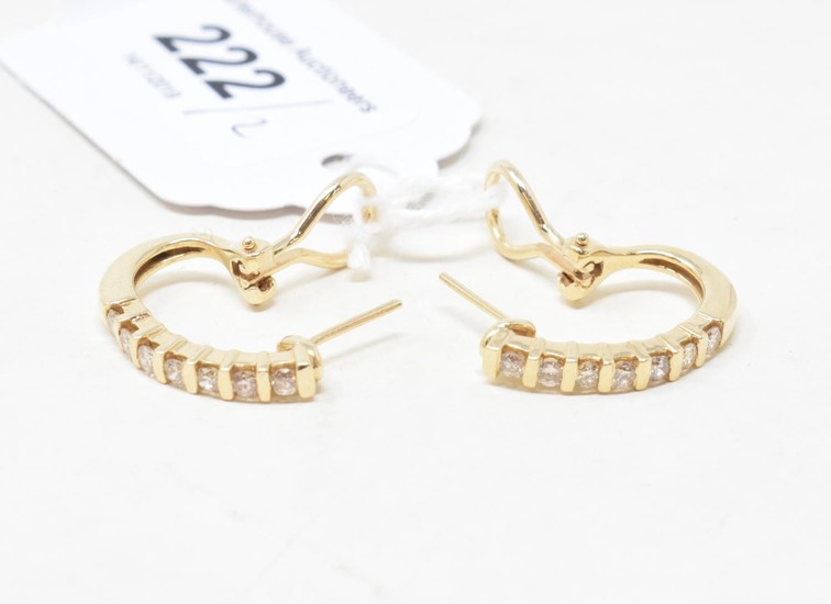 A pair of gold and diamond half hoop earrings