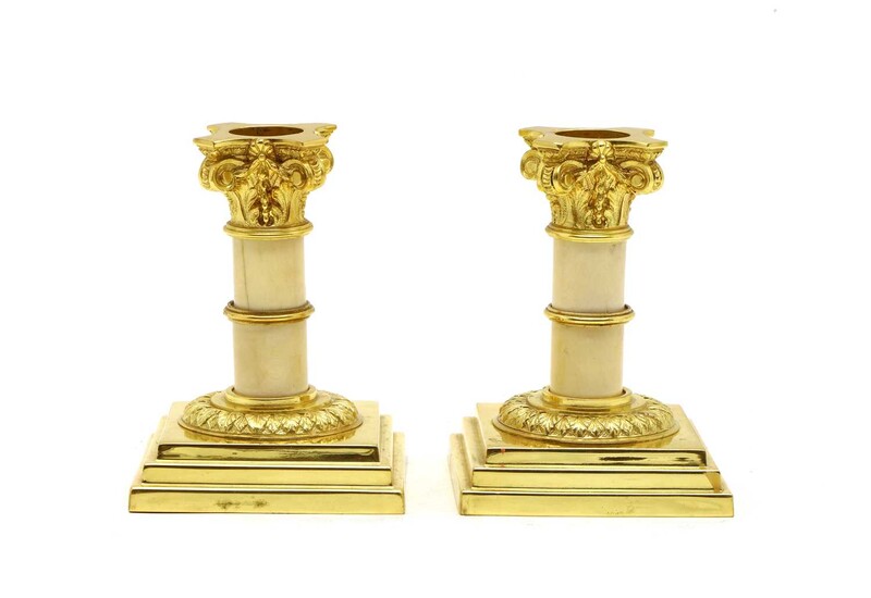 A pair of ormolu & ivory candlesticks