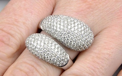 A pave-set diamond crossover dress ring. Estimated