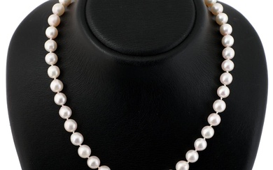 A pearl necklace set with numerous cultured pearls and a diamond clasp...