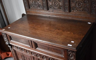 A period oak side cabinet having carved panel back , single drawer and double cupboards under, width