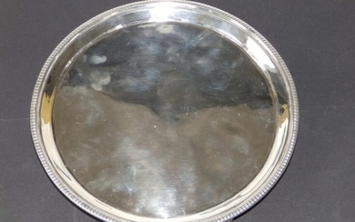 A plain George III circular silver salver with knurled...
